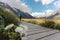 Wild buttercup flowers and a woman walking in Hooker Valley track. Mount Cook National Park