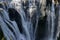 Wild cascade between stones in forest landscape