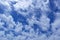 Wild cumulus clouds in the clear deep blue sky