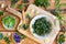 Wild edible spring plants on a wooden table