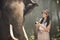 The wild elephants and Tourists in the forrest. Thai Elephant and Tourism asian women holding camera in elephant village. Surin,