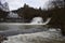 wild Elz waterfall during snow melting season with the bridge, Pyrmonter MÃ¼hle and Burg Pyrmont