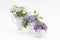 Wild flowers in three small vases on white background