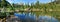 Wild forest lake in the Sayan Mountains, Natural Park Ergaki. Siberian nature. Wide panoramic view