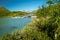 Wild glacial river flows through remote, green Arctic landscape on a sunny day of summer. Njoatsosjahka river and