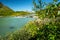 Wild glacial river flows through remote, green Arctic landscape on a sunny day of summer. Njoatsosjahka river and