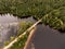 Wild huge pine tree forest and lake divides old wooden bridge in Canada Camping