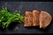 Wild lettuce with grilled tuna on a black plate, simple meal concept photography