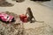 Wild monkey on the beach trying to open the bag.
