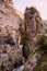 A wild mountain river squeezing between two craggy rocks in a gorge