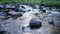 Wild mountain river water splashing in summer day