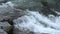 Wild mountain river water splashing in summer day