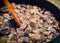 Wild mushrooms and onions fried in a cooking pan