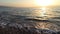 A wild and natural beach in the Dead Sea called Dragot Cliffs, waves break on the beach at sunrise in the early morning