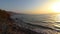 A wild and natural beach in the Dead Sea called Dragot Cliffs, waves break on the beach at sunrise in the early morning