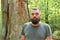 Wild nature. Man bearded hipster bright foliage background. Guy relax in forest. Exploring nature