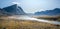 Wild Owl River winds through remote arctic landscape in Akshayuk Pass, Baffin Island, Canada. Moss valley floor and