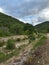 Wild panorama from mountains in Abruzzo, Italy. Cloudy sky and green trees