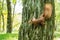 Wild red-haired squirrel on a tree in the forest. Space for text