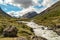 Wild river in the Jotunheimen National Park in Norway with mountain Styggehoe - way to the Spiterstulen settlement