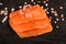 Wild salmon salted with coarse pink himalayan salt on black back
