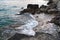 Wild sea panorama surrounded with sharp rock stone in summer on sunny sunset day. Danger of swimming in forbidden places