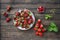 Wild strawberry and garden strawberry of new kind of Russian selection hybrid Kupchiha in vintage crockery plate on rustic wooden