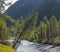 Wild taiga river. Forested shores, steep hillside