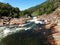 Wild water between reddish brown rocks - Creek in Yosemite, Sequoia and Kings Canyon National Park