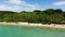 Wild white sand beach with coconut trees. Caramoan Islands, Philippines.