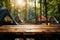 Wilderness retreat A wooden table amidst forest camping and tents