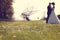 Wildflowers with bride and groom as silhouettes