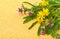 Wildflowers, chamomiles, milfoil on yellow sacking background