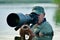 Wildlife photographer outdoor, standing in the water