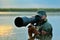 Wildlife photographer outdoor, standing in the water