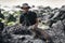 Wildlife photographer and tourist on Galapagos taking photo of Marine Iguana