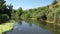 Wildlife of Russia: a small river among hills and meadows on a summer day