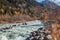 Wildly flowing stream in an alpine landscape in autumn