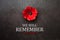 We Will Remember 11th November inscription with Poppy flower on rusty iron background. Remembrance Day.
