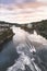 Willamette Falls in Portland Oregon with the industrial plants in the background and a speeding fishing boat