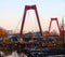 Willemsbrug, the red bridge in Rotterdam seen at sunset time over the harbor