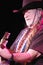Willie Nelson in Cowboy Hat Playing Guitar