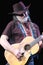 Willie Nelson with Old Guitar and Cowboy Hat