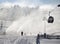 Willingen, Germany - February 7th, 2018 - Ski run with gondola lift and snow cannon shooting clouds of powdery snow