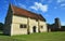 Willington Church, and Stables with blue  sky  and clouds.