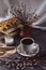 Willow twigs, cup of coffee, books and candle. Spring still life on a white and wooden background.