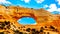 Wilson Arch under blue sky, a sandstone arch along US Highway 191, south of the town of Moab