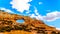 Wilson Arch under blue sky, a sandstone arch along US Highway 191, south of the town of Moab