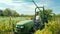 Wilson, NY, USA, October 2017: Farmers use a special machine to remove the protective network from the vineyard