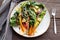 Wilted swiss chard salad with butter and garlic on rustic table